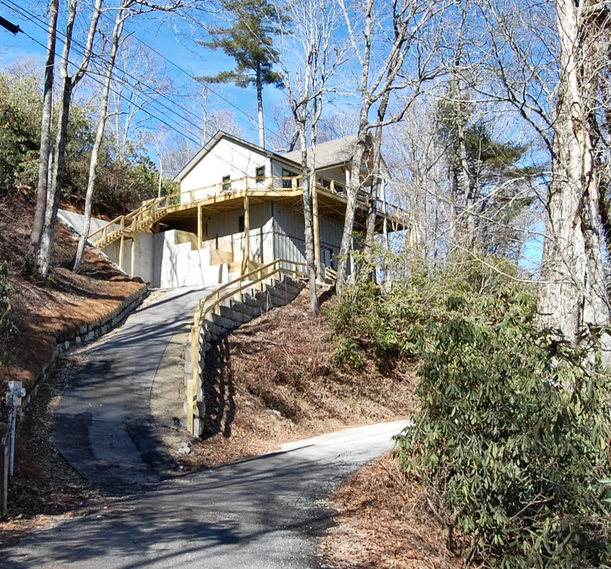 This exterior shot features The Owlery house nestled among tall trees, with a winding driveway leading up to it. The scene conveys tranquility and highlights the surrounding natural environment, suggesting the beginning of a journey from home into the neighborhood. The early morning light hints at a day of exploration ahead.